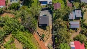 Aerial view of a house in a lush green neighborhood in Dominical, Costa Rica.