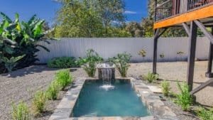Relaxing backyard with small pool, lush greenery, and outdoor space in Dominical.
