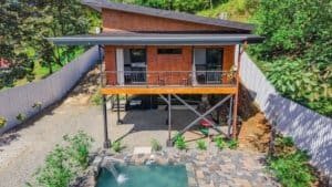 Modern Costa Rican home with elevated deck and lush surroundings.
