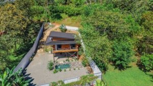 A fully equipped home with a garden and surrounding trees in Dominical, Costa Rica.