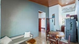 Interior view of a Costa Rican home with dining area and natural light.