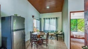 Interior view of a Costa Rican home with dining area and bedroom.