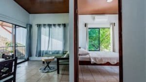 Interior view of a Costa Rican home with living room and bedroom.