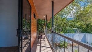 Balcony with seating overlooking lush green trees in Dominical, Costa Rica.