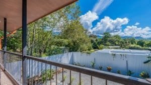 Scenic view of a Costa Rican home with lush greenery and blue sky.