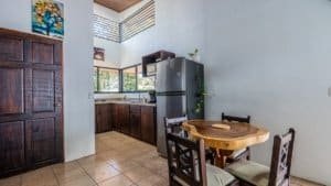 Interior view of a modern kitchen with wooden cabinets and a round dining table.