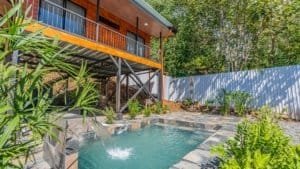Costa Rican home with pool, lush greenery, and outdoor space.