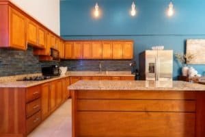 Stylish kitchen with wooden cabinets and stainless steel appliances in Uvita.