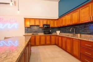 Modern kitchen with wooden cabinets and granite countertops in Uvita.