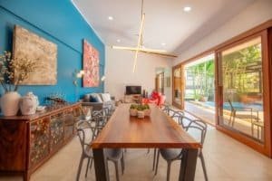 Modern living room with large glass doors opening to outdoor pool in Uvita.