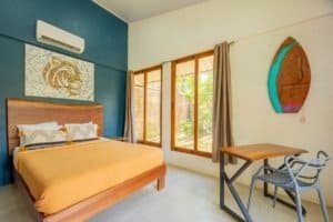 Comfortable bedroom with large windows and tropical decor near Uvita.