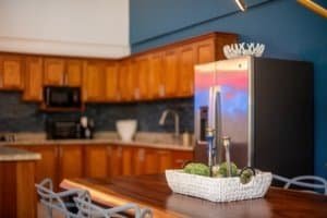 Stylish kitchen with wooden cabinets and stainless steel appliances in Uvita.