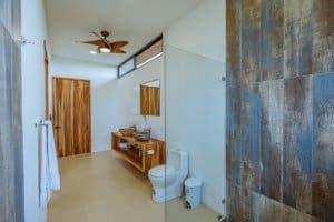 Contemporary bathroom with wooden accents and ocean view in Dominical.