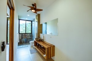 Contemporary bathroom with ocean view window and wooden accents.