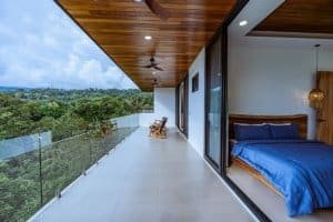 Balcony of luxury house with ocean view and modern interior design.
