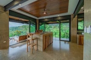 Contemporary living space with large glass windows and scenic views in Dominical.