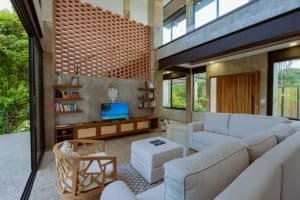 Bright living room with large windows, modern furniture, and natural decor.