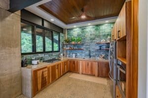 Contemporary kitchen with wooden cabinets and ocean view in Dominical.