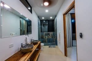 Contemporary bathroom with dual vessel sinks and ocean view window.