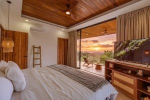 Luxury modern house interior with wooden ceiling and ocean view.