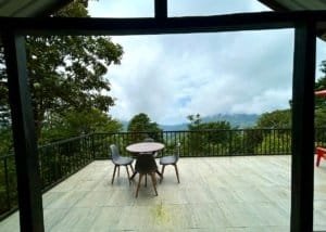 Balcony overlooking lush green mountains and ocean in Dominical, Costa Rica.