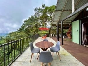 Outdoor dining area with ocean and valley views in Dominical, Costa Rica.