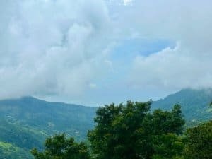 Scenic view of lush green mountains and cloudy sky in Dominical, Costa Rica.