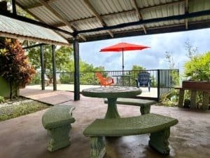 Covered deck with table, chairs, and ocean view in Dominical, Costa Rica.