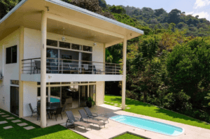 Modern Costa Rican home with ocean view, pool, and lush greenery.