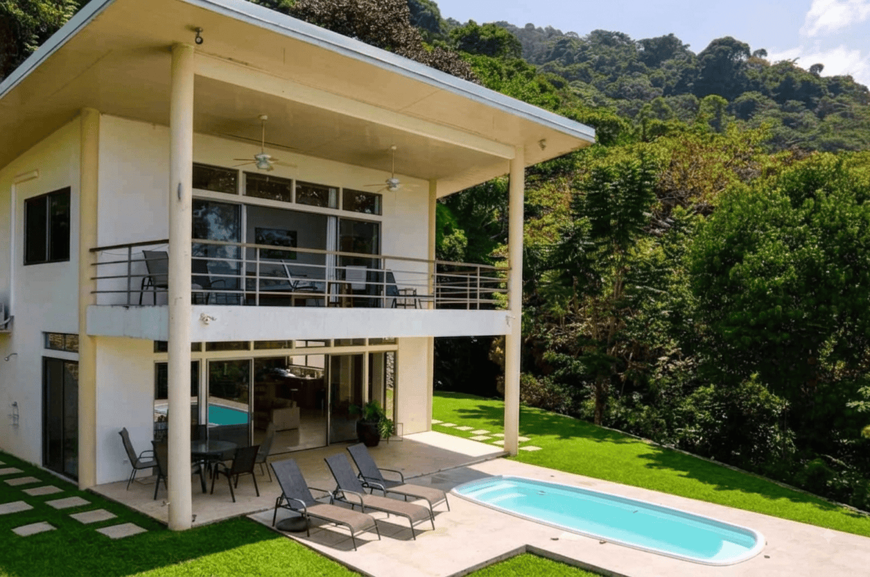 Modern Costa Rican home with ocean view, pool, and lush greenery.