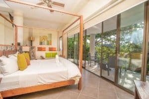 Spacious bedroom with balcony and ocean view in Costa Rica.