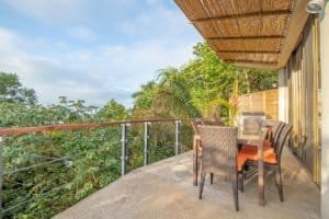 Balinese-style balcony with ocean view and outdoor dining area in Dominical.