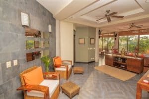 Spacious Dominical living room with ocean view, modern decor, and tropical ambiance.