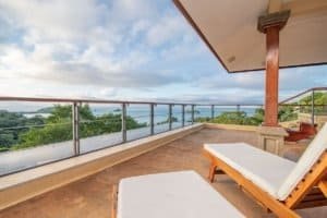Balinese-style balcony with ocean view and lounge chairs in Dominical.