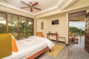 Spacious bedroom with ocean view, balcony, and modern decor in Costa Rica.