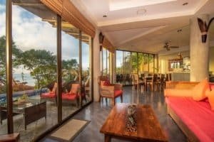 Spacious living room with ocean view, outdoor seating, and modern decor.