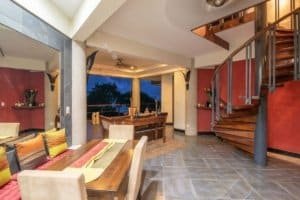 Spacious interior of a Balinese-inspired home with ocean view and modern decor.