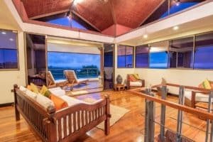 Spacious living room with ocean view and tropical decor in Dominical.