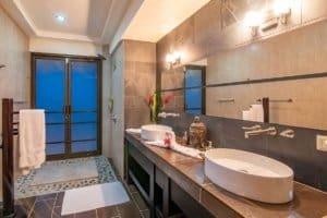 Modern bathroom with ocean view, stylish decor, and elegant fixtures.
