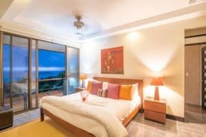 Elegant bedroom with ocean view, tropical decor, and modern amenities in Dominical.