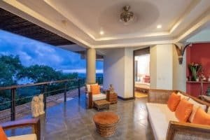 Balinese-style home with ocean view, spacious balcony, and tropical decor.