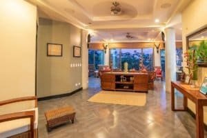 Spacious living room with ocean view, tropical decor, and modern furnishings.