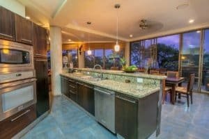 Modern kitchen with granite counters and ocean view in Dominical real estate.