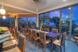 Elegant dining area with ocean view and large glass windows in Dominical.
