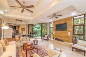 Spacious living room with large windows and ocean view in Dominical.