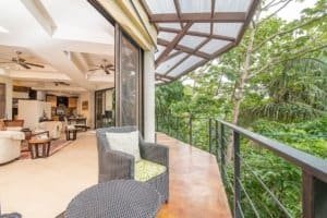 Balinese-inspired home balcony overlooking lush tropical forest in Dominical.