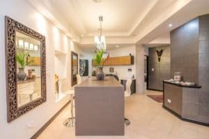 Elegant interior of a Balinese-inspired home with modern decor and ocean view.