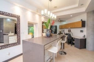 Contemporary kitchen with island, stylish lighting, and modern appliances.