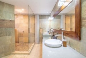 Modern bathroom with walk-in shower and ocean view in Dominical.