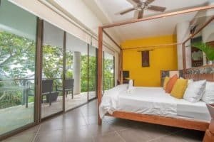 Bedroom with balcony and ocean view in Dominical, Costa Rica.